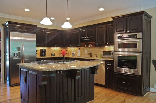 Santa Cecilia with Walnut Stain Dark Cabinets and Cream Subway Tiles with Light Color Hardwood Flooring